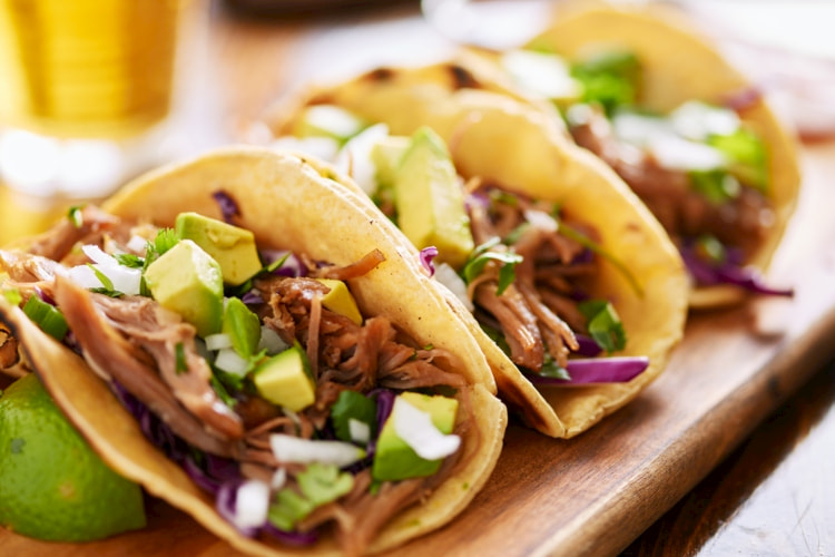 carnitas-tacos-on-wooden-tray