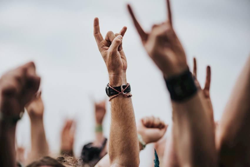 hands raise during a rock music performance