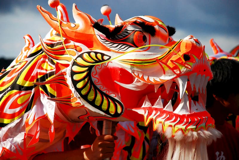 a golden dragon costume prepares for the LA golden dragon parade