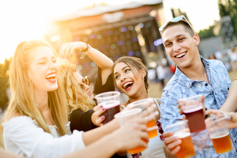 friends cheers at a beer festival in los angeles, california