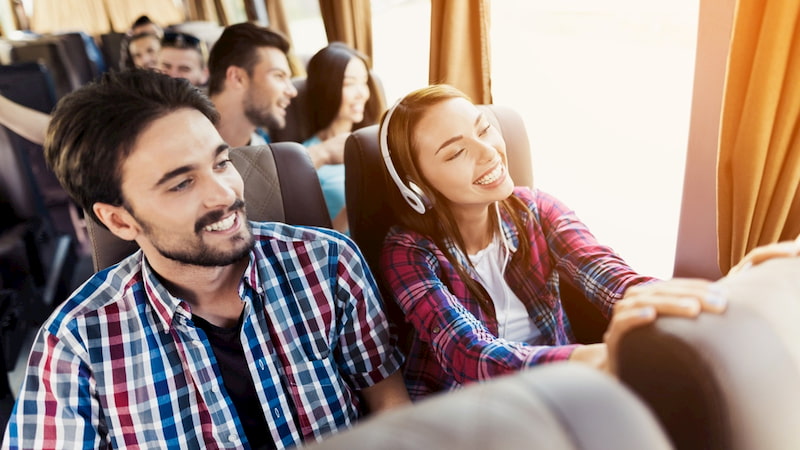 happy friends ride in a charter bus in Los Angeles