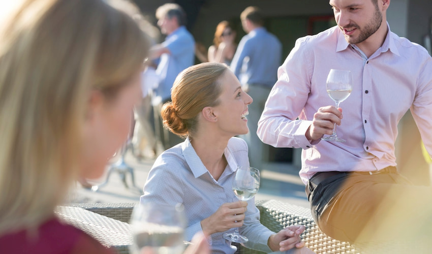employees sip wine and chat at a corporate event in Los Angeles California