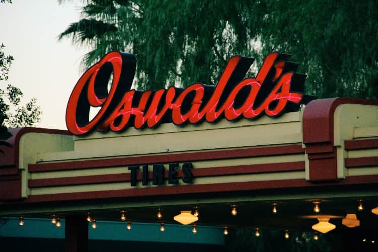 A neon red sign with the name "Oswald's"