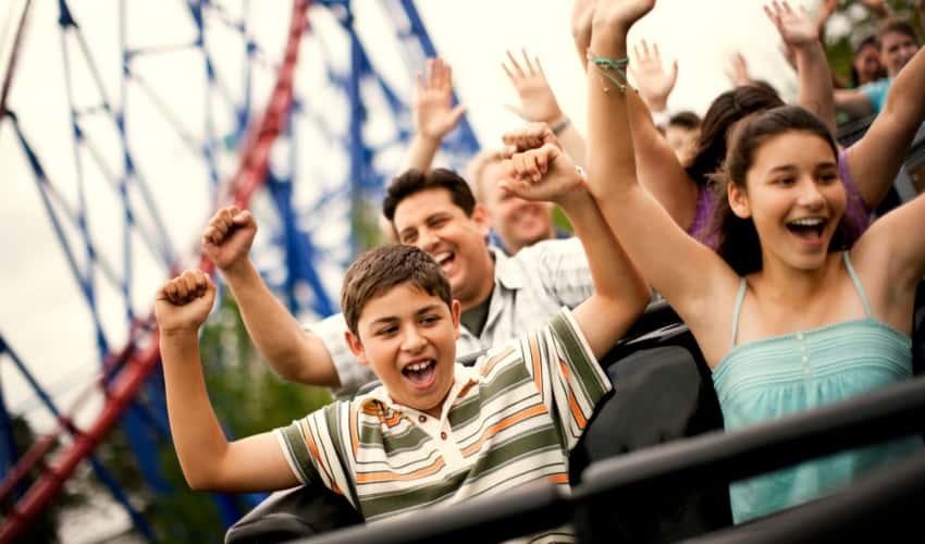 A family riding a rollercoaster and having fun