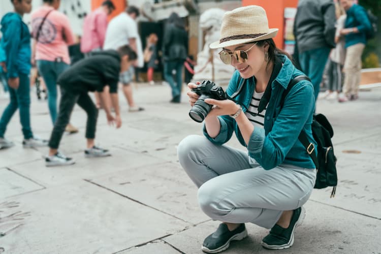 Tourist taking photos of celebrity handprints in LA