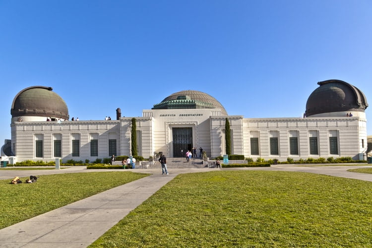 the green lawn in front of griffith observatory on a clear day