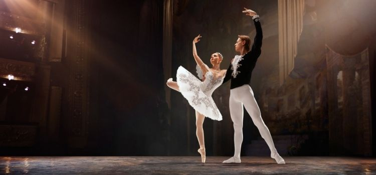 male and female ballerina performing on stage