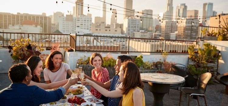 group eating dinner overlooking los angeles skyline