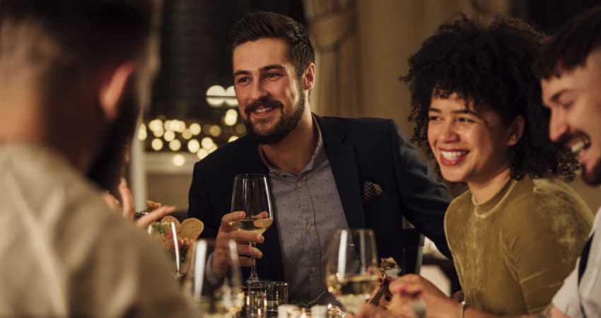 a group of friends having dinner with wine