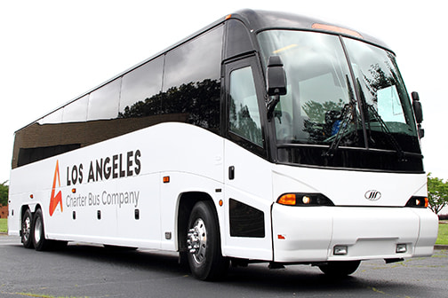 a plain white charter bus with a "LA Charter Bus Company" logo