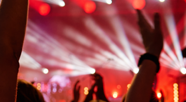 people throw their hands up in the air at a concert