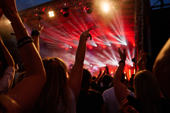people throw their hands up at a concert
